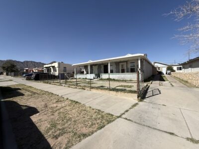 light blue, distressed multifamily building before expensive remodeling in El Paso TX
